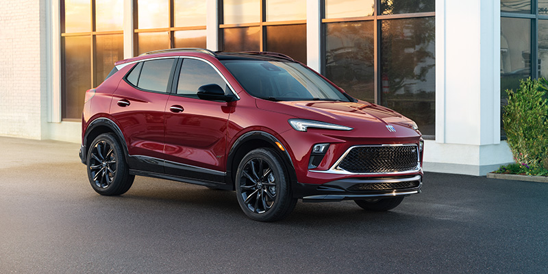 a red 2026 Buick Encore GX SUV parked next to a building in Medina, OH